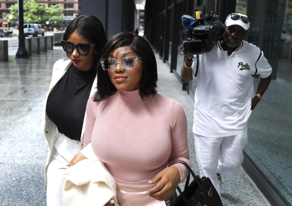 CORRECTS THE DESCRIPTION OF THE TWO WOMEN AS HAVING LIVED WITH R. KELLY RATHER THAN GIRLFRIENDS - Joycelyn Savage, left, and Azriel Clary, women who lived with R&B singer R. Kelly, depart the Dirksen Federal Courthouse after Kelly's hearing, Tuesday, July 16, 2019, in Chicago. U.S. District Judge Harry Leinenweber ordered R. Kelly held in a Chicago jail without bond on sex-related charges, saying that R&B singer had failed to convince the court that he would not be a danger if set free. (AP Photo/Charles Rex Arbogast)