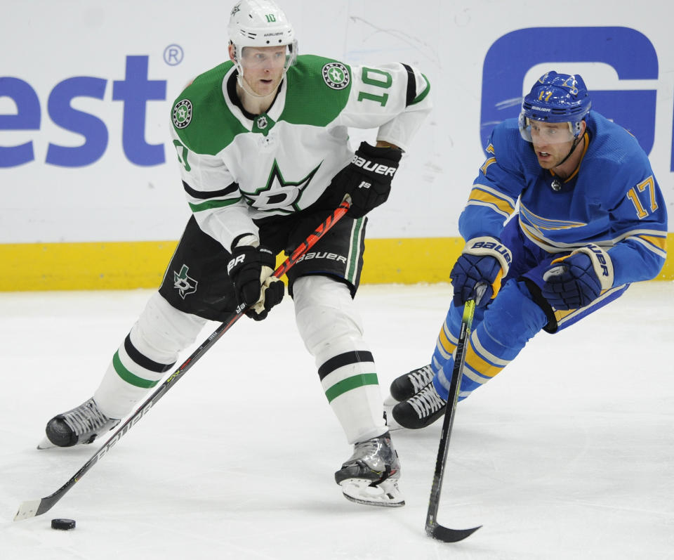 Dallas Stars' Corey Perry (10) looks to pass in front of St. Louis Blues' Jaden Schwartz (17) during the third period of an NHL hockey game, Saturday, Feb. 29, 2020, in St. Louis. (AP Photo/Bill Boyce)