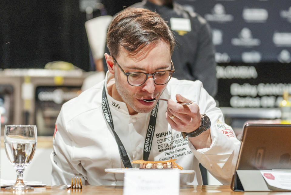 Jury member Patrice Demers tastes a soufflé during the Coupe de Monde de la Patisserie, or World Pastry Cup, at the Ernest N. Morial Convention Center in New Orleans, Tuesday, June 11, 2024. (Matthew Perschall/The Times-Picayune/The New Orleans Advocate via AP)