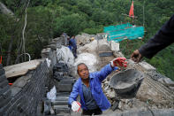 <p>People work on the reconstruction of the Jiankou section of the Great Wall, located in Huairou District, north of Beijing, China, June 7, 2017. (Photo: Damir Sagolj/Reuters) </p>