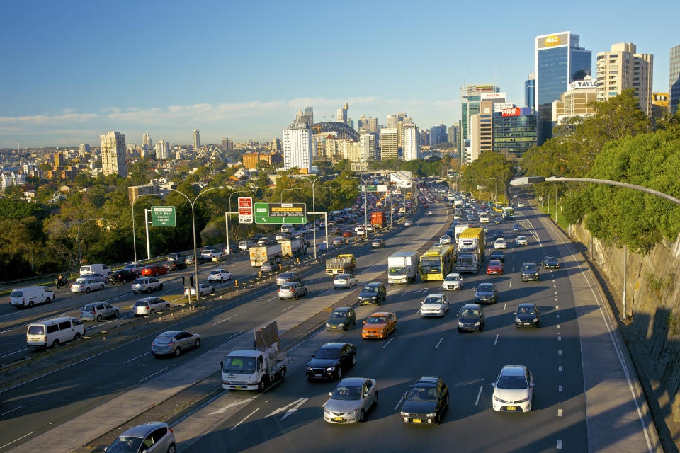 Streams of early morning traffic on the Bradfield Highway, Sydney. Buildings of North Sydney on right & Sydney CBD & Bridge ahead.