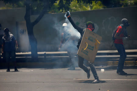 Demonstrators clash with riot security forces while participating in a strike called to protest against Venezuelan President Nicolas Maduro's government in Caracas, Venezuela, July 20, 2017. The writing on shield reads "Activate yourself and resist! chains down, fear is lost". REUTERS/Andres Martinez Casares