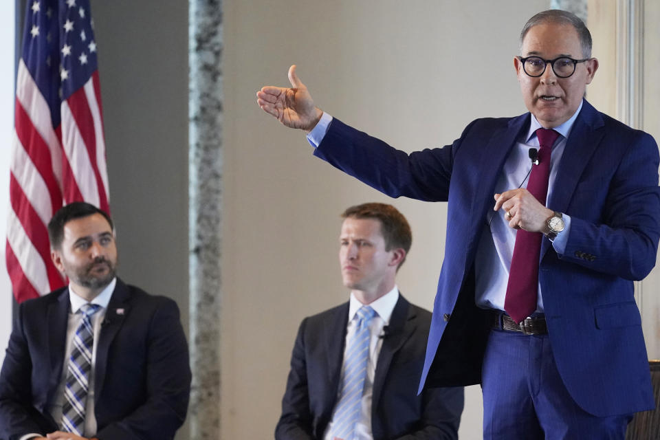FILE - Scott Pruitt speaks during a candidate's forum for U.S. Senate Republican candidates May 11, 2022, in Oklahoma City. Looking on are candidates Oklahoma State Sen. Nathan Dahm, left, and Luke Holland, center. (AP Photo/Sue Ogrocki, File)
