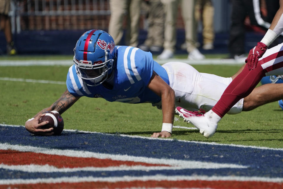 Mississippi quarterback Matt Corral (2) stretches over the goal line for a seven-yard touchdown run against Arkansas during the first half of an NCAA college football game, Saturday, Oct. 9, 2021, in Oxford, Miss. (AP Photo/Rogelio V. Solis)