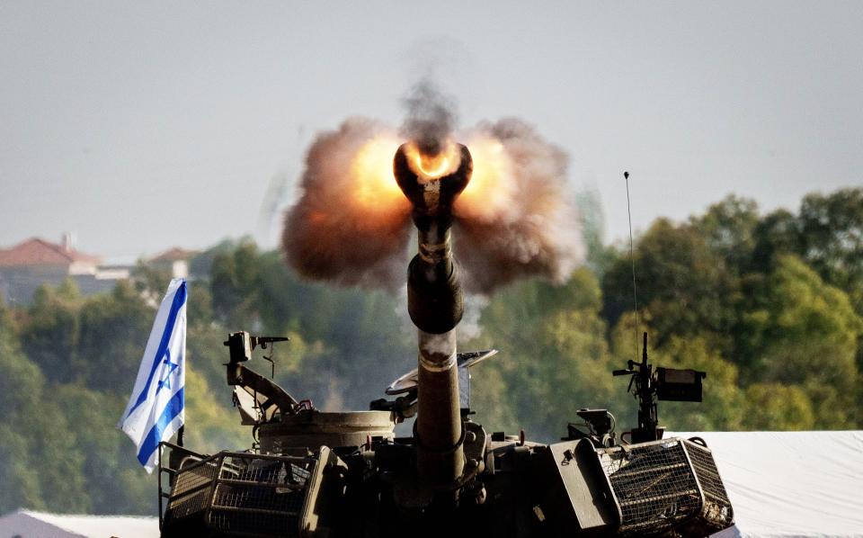 An Israeli self-propelled Howitzer artillery gun fires towards the Gaza Strip