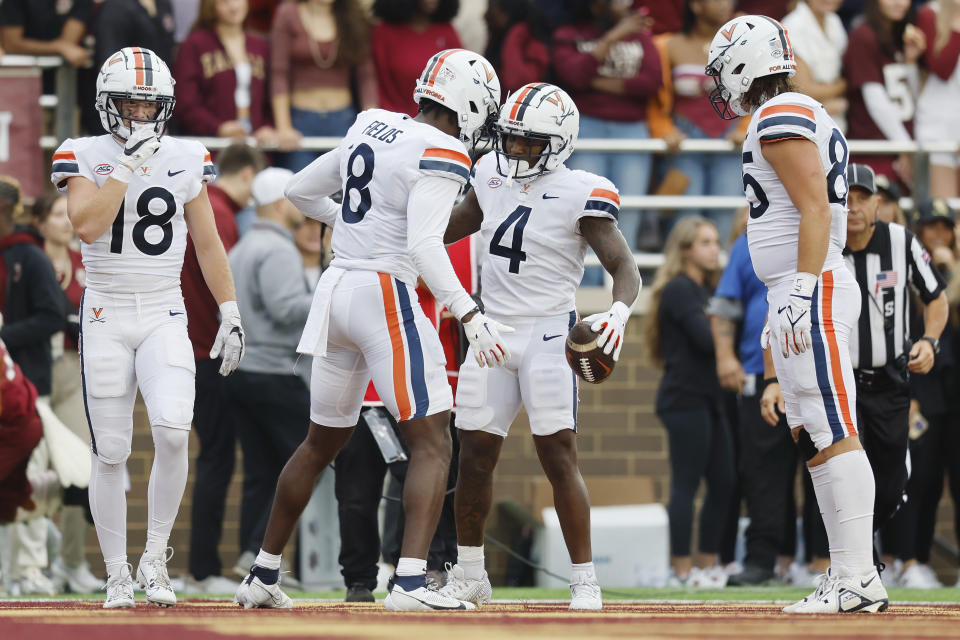 Virginia wide receiver Malik Washington (4) celebrates his touchdown with wide receiver Malachi Fields (8) during the first half of an NCAA college football game against Boston College, Saturday, Sept. 30, 2023, in Boston. (AP Photo/Michael Dwyer)