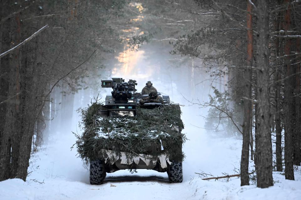 Soldiers of the German armed forces Bundeswehr are seen on a camouflaged Boxer armoured fighting vehicle during an exercise of the German contingent of NATO's Enhanced Forward Presence on March 7, 2023 in Pabrade, Lithuania.