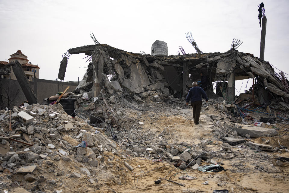 Palestinians look at a house destroyed in an Israeli strike in Rafah, Gaza Strip on Tuesday, March 26, 2024. (AP Photo/Fatima Shbair)