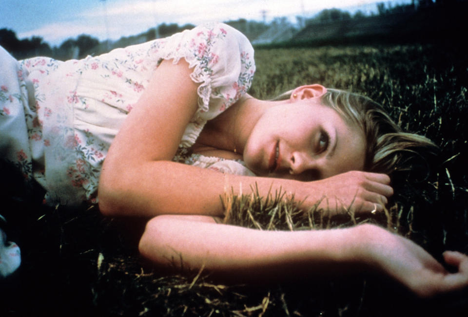 Kirsten Dunst lying in the grass