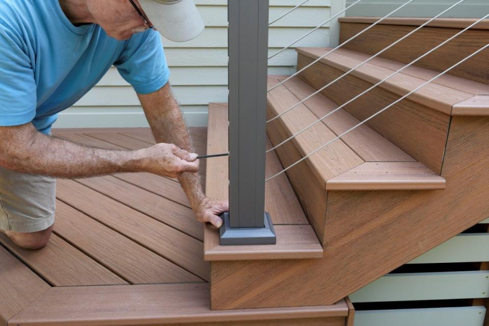 Man repairing step railing.