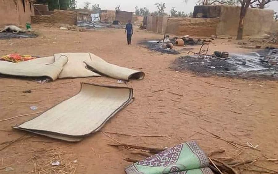 A boy from Niger walks in the village of Tchombangou following a deadly attack which killed seventy villagers - Shutterstock