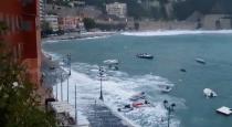 Waves flood the street in Villefranche-Sur-Mer