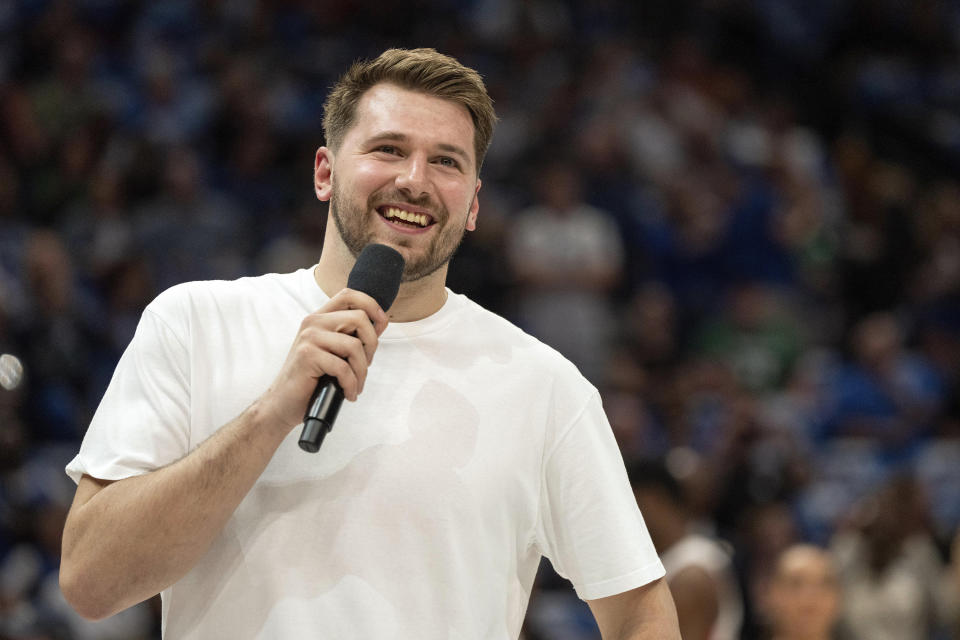 Dallas Mavericks' Luka Doncic acknowledges the crowd before an NBA basketball game against the Detroit Pistons, Friday, April 12, 2024, in Dallas. Doncic was not going to play due to left ankle soreness (AP Photo/Jeffrey McWhorter)