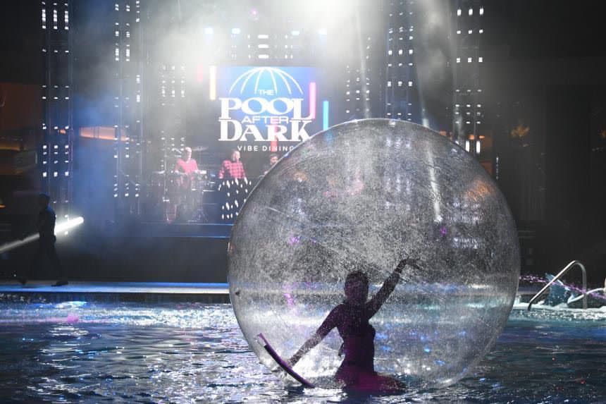 Expect entertaining oddities at Vibe Dining at Harrah's Resort like a woman dancing inside a see-through sphere in the pool.