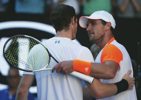 Tennis - Australian Open - Melbourne Park, Melbourne, Australia - 22/1/17 Germany's Mischa Zverev embraces after winning his Men's singles fourth round match against Britain's Andy Murray. REUTERS/Thomas Peter