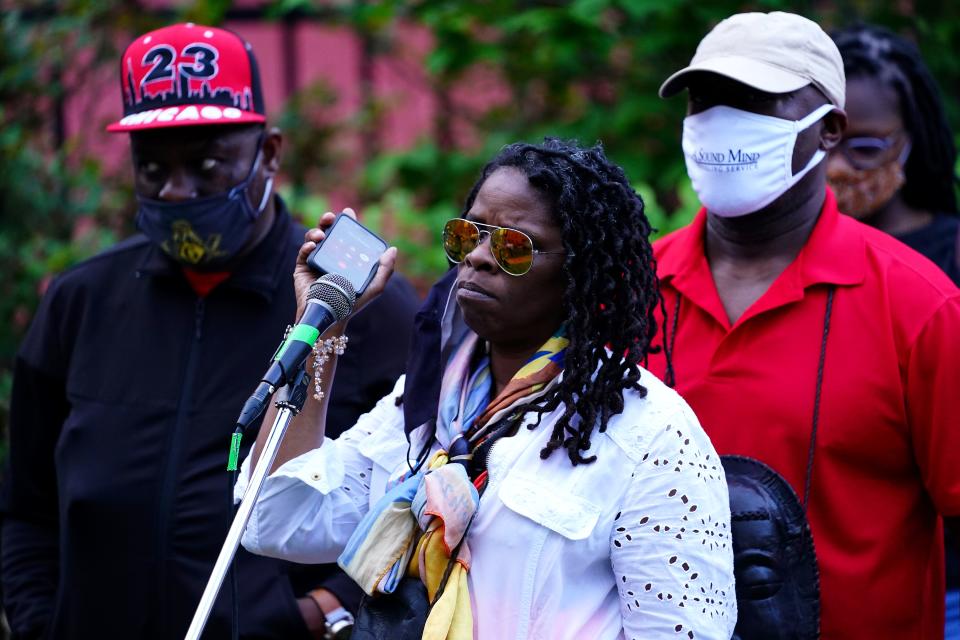 Iris Roley, a member of the Cincinnati Black United Front, holds the phone while Terry Thomas, Timothy Thomas's uncle, is on the line. Concerned Citizens for Justice and the Cincinnati Black United Front join to observe the 20th anniversary of the death of Timothy Thomas, Wednesday, April 7, 2021, at Washington Park and near the intersection of 13th and Republic streets in the Over-the-Rhine neighborhood of Cincinnati. Thomas was 19 years old when he was shot on April 7, 2001 by a Cincinnati Police officer. The killing sparked several days protesting and civil unrest.