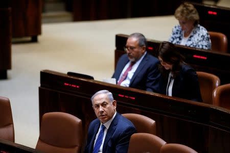 Israeli Prime Minister Benjamin Netanyahu (front) and Avigdor Lieberman head of far-right Yisrael Beitenu party attend the opening of the summer session of the Knesset, the Israeli parliament in Jerusalem, May 23, 2016. REUTERS/Ronen Zvulun