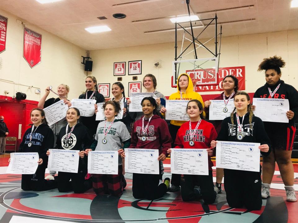 First-place wrestlers show off their medals after winning titles at the 2022 BCWCA girls wrestling invitational. Jan. 16, 2022.