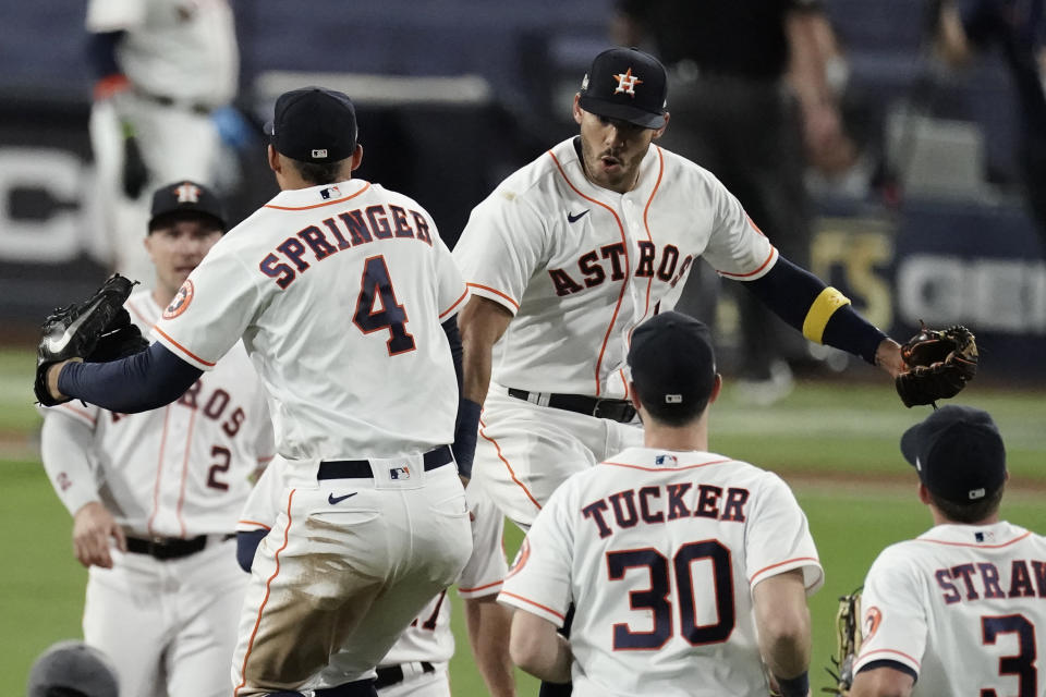 Houston Astros George Springer (4) celebrates with teammates after Game 4 of a baseball American League Championship Series against the Tampa Bay Rays, Wednesday, Oct. 14, 2020, in San Diego. The Astros defeated the Rays 4-3 and the Rays lead the series 3-1 games. (AP Photo/Jae C. Hong)