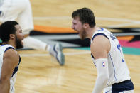 Dallas Mavericks guard Luka Doncic, right, celebrates a score against the San Antonio Spurs with Jalen Brunson (13) during the second half of an NBA basketball game in San Antonio, Friday, Jan. 22, 2021. (AP Photo/Eric Gay)