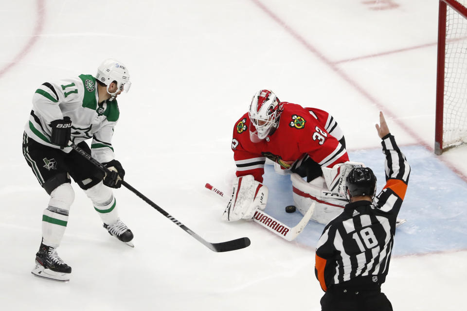 Dallas Stars center Andrew Cogliano (11) scores a short handed goal past Chicago Blackhawks goaltender Kevin Lankinen (32) during the third period of an NHL hockey game Tuesday, April 6, 2021, in Chicago. (AP Photo/Jeff Haynes)