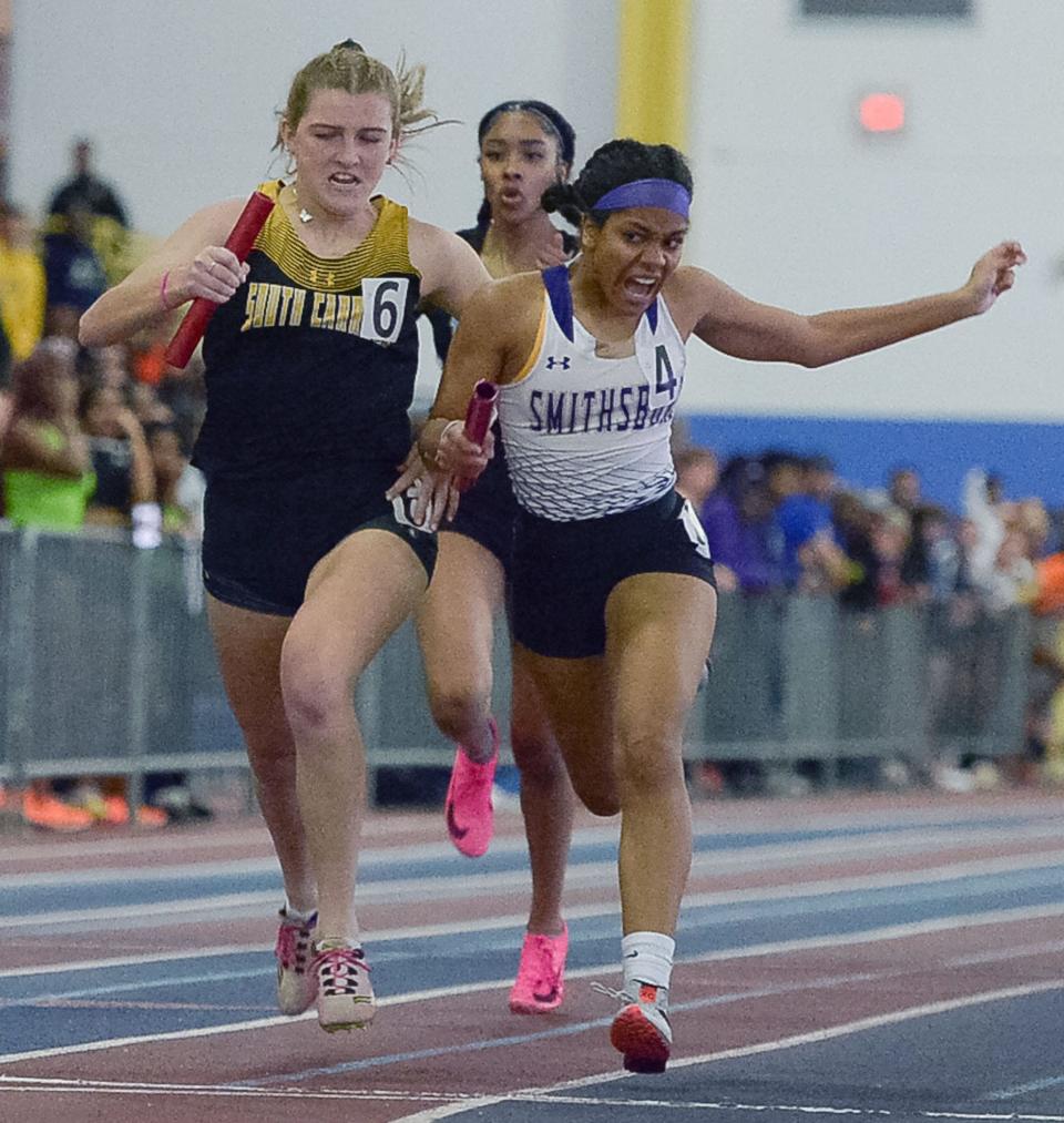 Smithsburg's Trenity Green, right, and South Carroll's Lauren Chelsey battle it out for first place in the Class 1A girls 4x200 relay. Smithsburg won the event after South Carroll was disqualified.