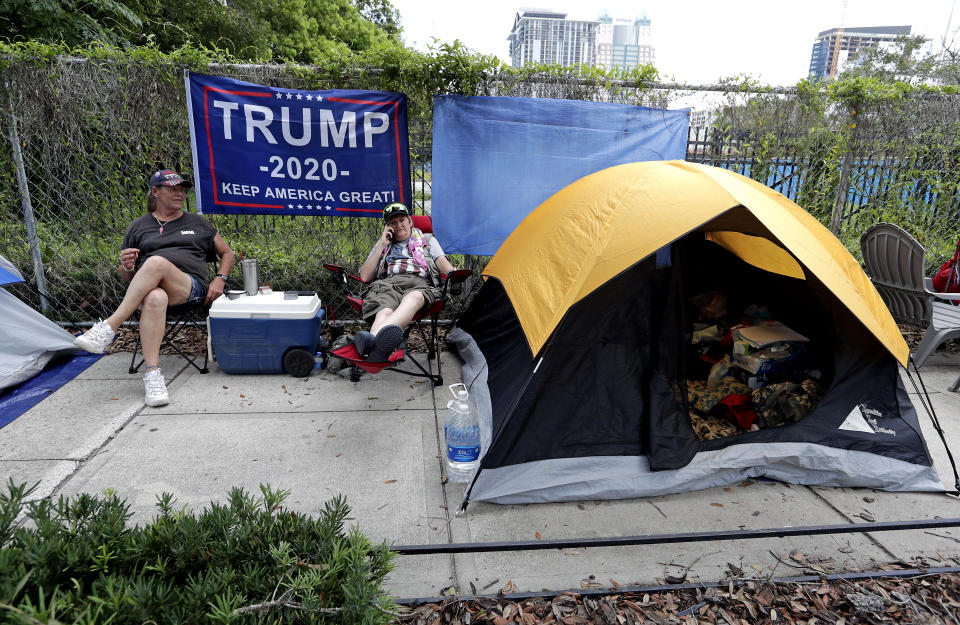 Anna Connelly, left, and Jeanna Gullett supporters of President Donald Trump, make camp Monday, June 17, 2019, in Orlando, Fla. as they wait to attend a rally for the president on Tuesday evening. (AP Photo/John Raoux)