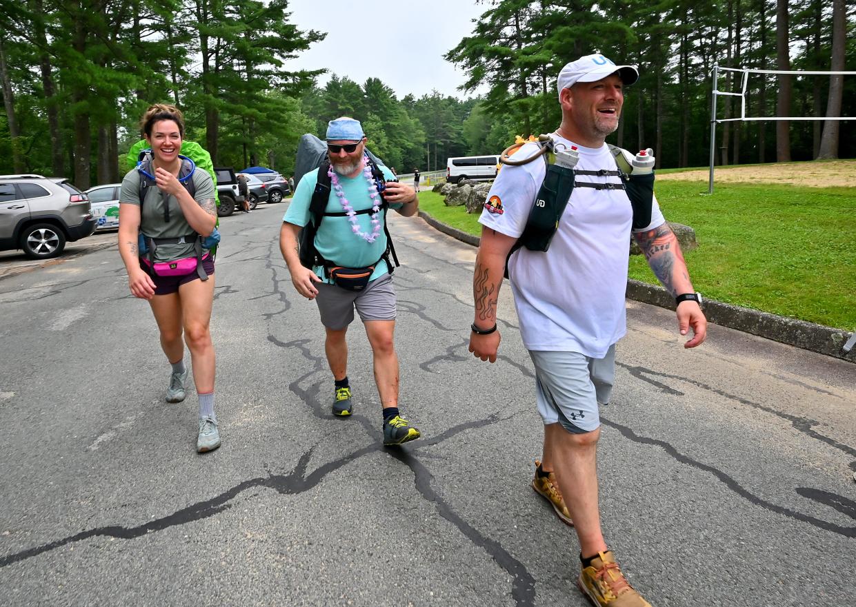 Ruckers, from left, Jessica Bridge of Shrewsbury, Dave Smith of Worcester and Jason Lyons of Plainfield, Conn., head back out on the trail from the Barre Falls Dam aid station in Hubbardston.