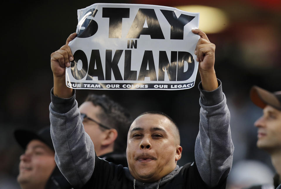 An Oakland Raiders fan holds up a sign before an NFL football game between the Raiders and the Denver Broncos in Oakland, Calif., Monday, Dec. 24, 2018. (AP Photo/John Hefti)