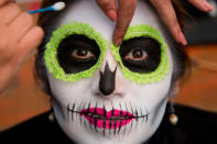 <p>A woman has her make up applied as she waits for the start of a Day of the Dead parade to begin along Mexico City’s main Reforma Avenue, Saturday, Oct. 28, 2017. (Photo: Eduardo Verdugo/AP) </p>