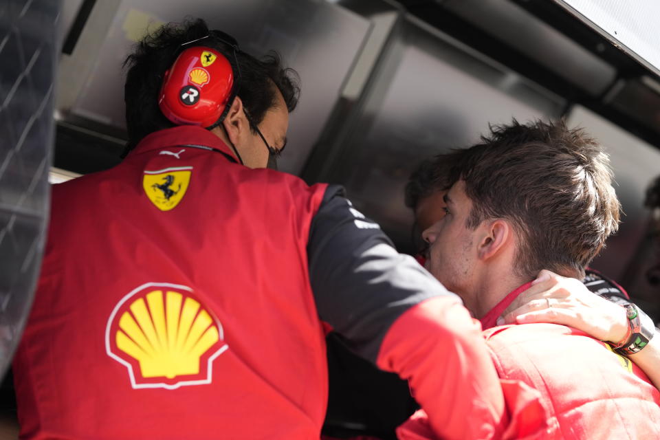 Ferrari driver Charles Leclerc of Monaco reacts as he speaks with his teammates at the pit lane after his car's breakdown during the Spanish Formula One Grand Prix at the Barcelona Catalunya racetrack in Montmelo, Spain, Sunday, May 22, 2022. (AP Photo/Pool/Manu Fernandez)