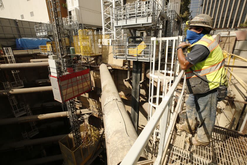 LOS ANGELES, CA - JUNE 03: Edgar Valles, a walking boss for LA Metro watches the site before Sen. Alex Padilla, D-California, was given a tour of the Purple (D) Line Extension Project's Century City station site as part of his statewide infrastructure listening tour. Padilla toured the excavation site to highlight federal funding as essential to the construction and completion of the Purple Line project on the westside. According to contact, Metro is slated to receive approximately $5.4 billion in federal funding and low-interest loans to complete the project. Century City on Thursday, June 3, 2021 in Los Angeles, CA. (Al Seib / Los Angeles Times).