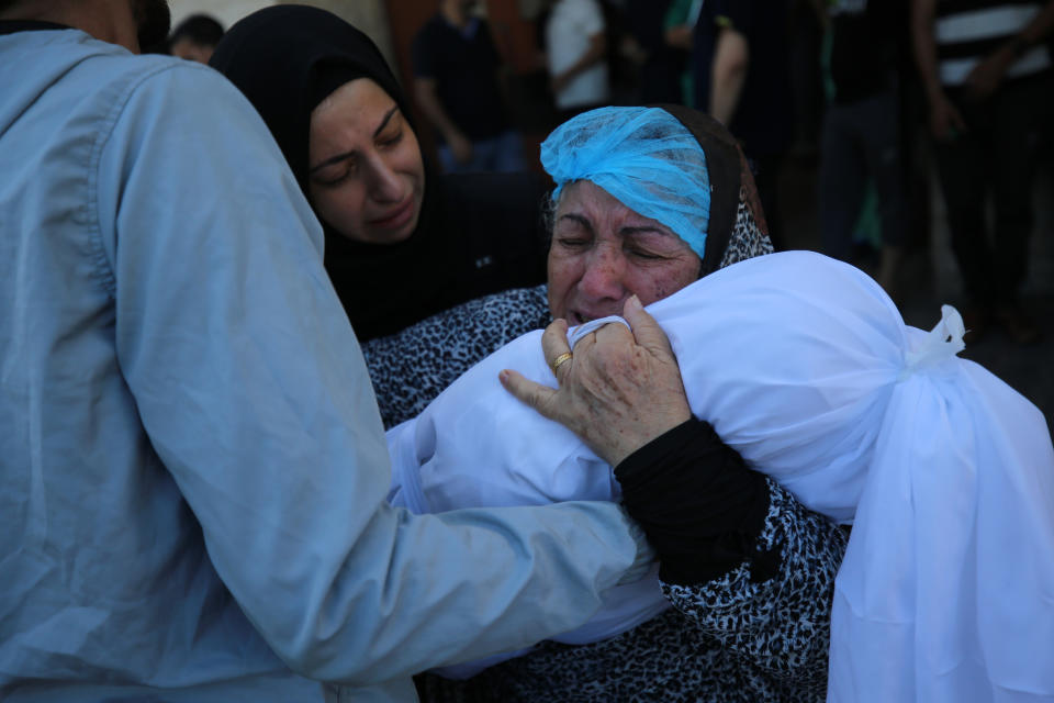 10月15日，在加沙中部城鎮 Deir al-Balah，一名巴勒斯坦人抱著孫兒的屍體痛哭。(Photo by Majdi Fathi/NurPhoto via Getty Images)