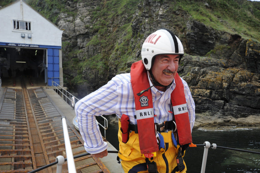 These pictures show Boycie actor John Challis ticking off one of his bucket list wishes before he died - launching down the slipway of a lifeboat station (August 09). See SWNS story SWPLboycie; Tributes have been paid to John Challis, best known for playing Boycie in BBC sitcom Only Fools and Horses, who has died at the age of 79. His family said he died 