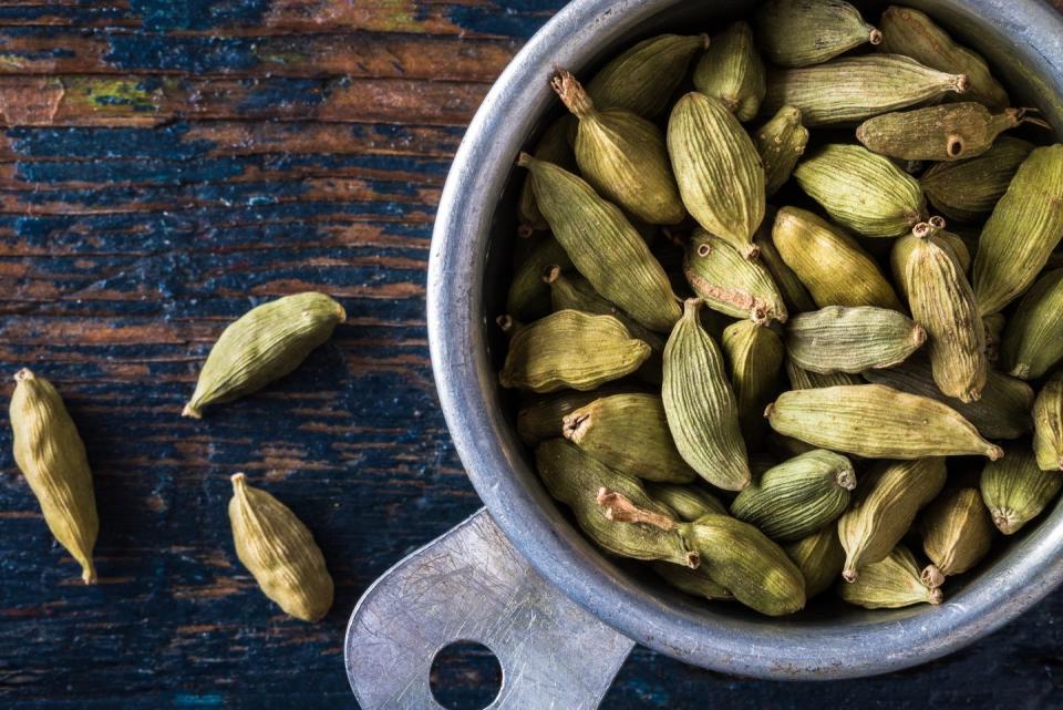 close up of cardamom in container on table