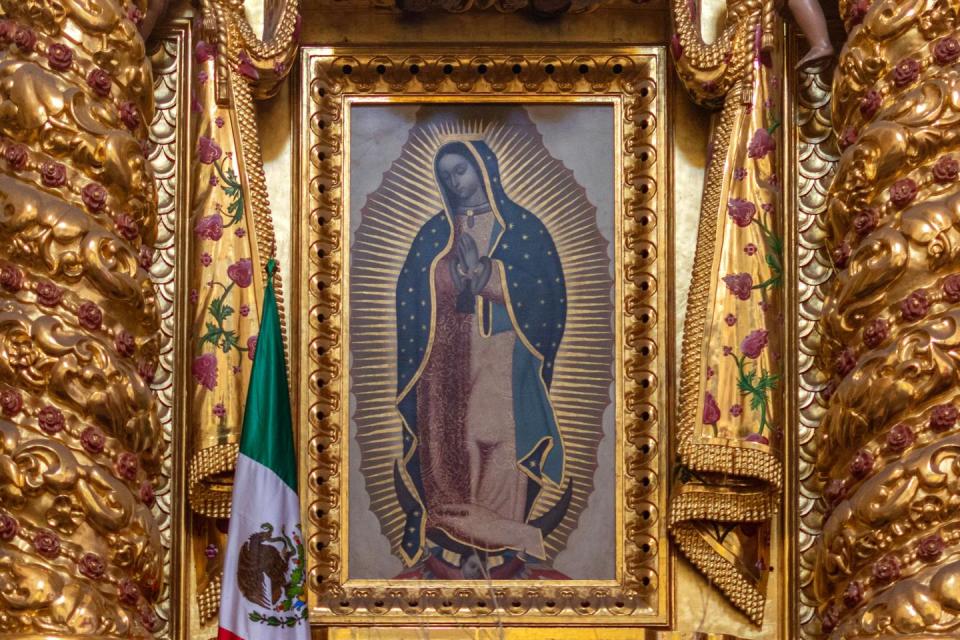 An altar inside the Monastery of Santo Domingo de Guzman in Oaxaca, Mexico, depicts the Virgen of Guadalupe. <a href="https://www.gettyimages.com/detail/photo/our-lady-of-guadalupe-shrine-royalty-free-image/1207063275?phrase=virgen+de+guadalupe&searchscope=image%2Cfilm&adppopup=true" rel="nofollow noopener" target="_blank" data-ylk="slk:Gabriel Perez/Moment via Getty Images;elm:context_link;itc:0;sec:content-canvas" class="link ">Gabriel Perez/Moment via Getty Images</a>