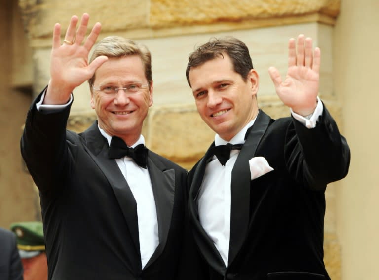 Then German Foreign Minister Guido Westerwelle (L) and his partner Michael Mronz arrive on the red carpet for the Richard Wagner opera festival in Bayreuth, on July 25, 2011