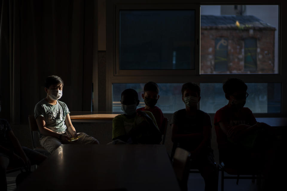 Students wearing face masks to prevent the spread of coronavirus sit in their classroom in a school in Barcelona, Spain, Monday, Sept. 14, 2020. (AP Photo/Emilio Morenatti)