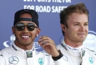 Formula One - F1 - British Grand Prix 2015 - Silverstone, England - 4/7/15 Mercedes' Lewis Hamilton celebrates his pole position in qualifying with Nico Rosberg (R) Reuters / Andrew Yates Livepic