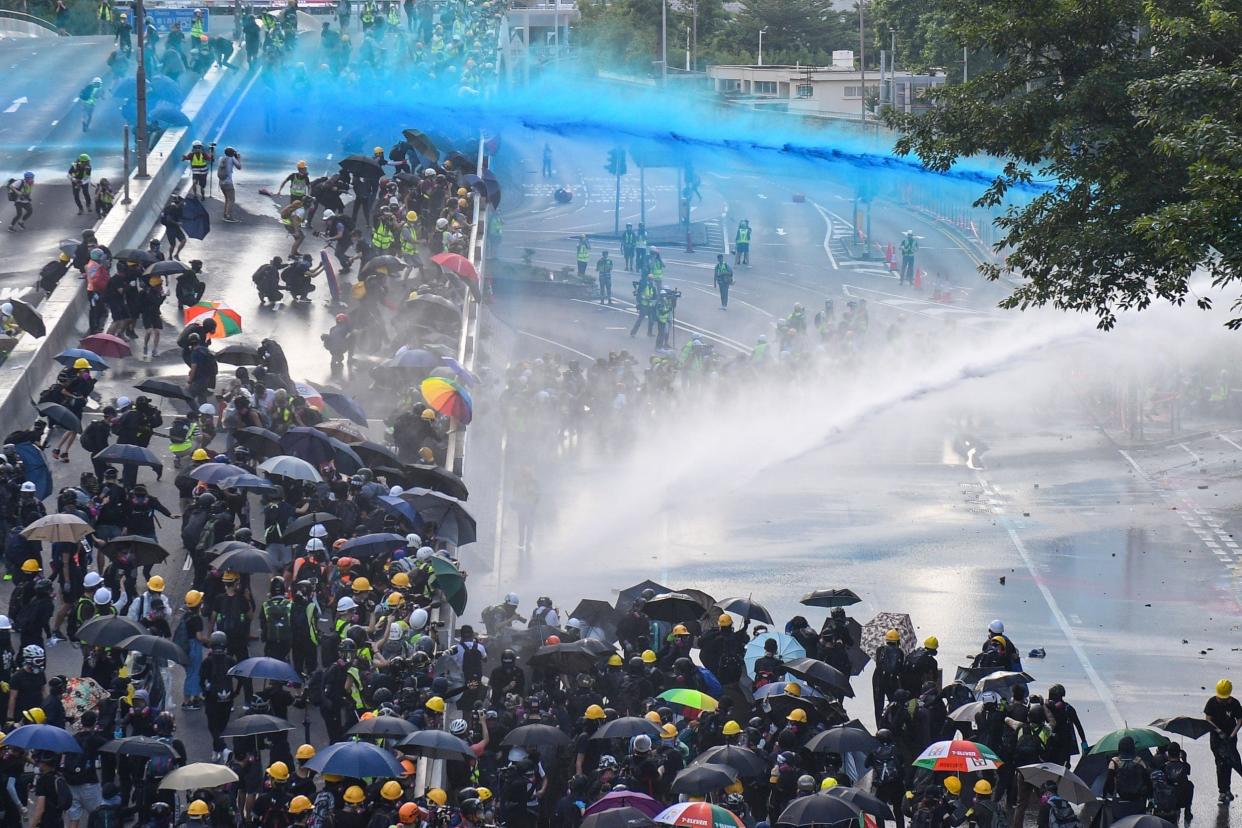 Pro-democracy protesters react as police fire water cannons outside the government headquarters in Hong Kong: AFP/Getty Images