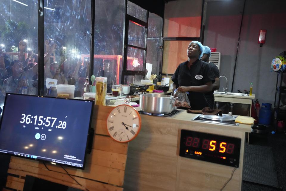 Chef Hilda Baci cooks to establish a new Guinness world record for the "longest cooking marathon", the 97-hour cook-a-thon, in Lagos, Nigeria, Thursday, May 11, 2023. A Nigerian chef on Monday continued her quest to set a new global record for the longest hours of nonstop cooking after surpassing the current record of 87 hours and 45 minutes. By 15:00 GMT on Monday, Hilda Baci had cooked for more than 97 hours, becoming a national sensation and to the cheering of many in Nigeria's commercial hub of Lagos where her kitchen is set. (AP Photo/Sunday Alamba)