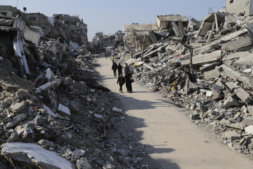 Palestinians walk through the destruction from the Israeli offensive in Jabaliya refugee camp in the Gaza Strip on Thursday, Feb. 29, 2024. (AP Photo/Mahmoud Essa)