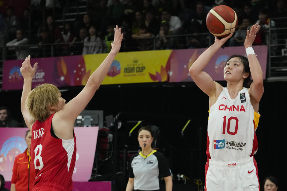 Japan's Maki Takada, left, attempts to block a shot from China's Zhang Ru during the Asia Cup women's basketball final in Sydney, Australia, Sunday, July 2, 2023. (AP Photo/Mark Baker)