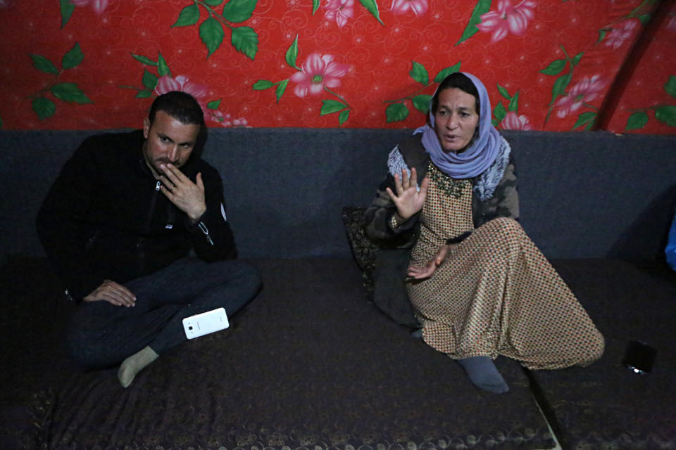 In this Thursday, Feb. 28, 2019 picture, Baseh Hammo, a Yazidi woman who escaped enslavement by Islamic State group militants, sits with a relative in a camp for displaced people outside Dahuk, Iraq. Yazidi women enslaved by IS who escaped captivity say there could be hundreds of other women still missing, women who may never return home. They say they fear many perished in bondage or war while others chose to remain in captivity to stay with the children they were forced to have. (AP Photo/Khalid Mohammed)