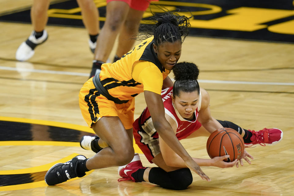 Iowa guard Tomi Taiwo, left, fights for a loose ball with Ohio State guard Madison Greene, right, during the first half of an NCAA college basketball game, Wednesday, Jan. 13, 2021, in Iowa City, Iowa. (AP Photo/Charlie Neibergall)