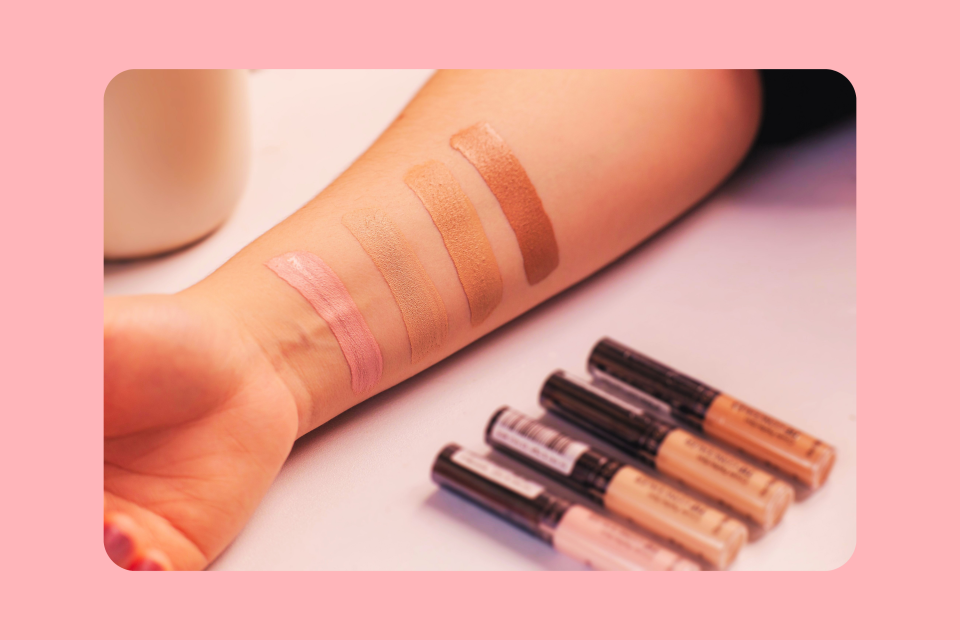Concealer shades applied to a woman's arm