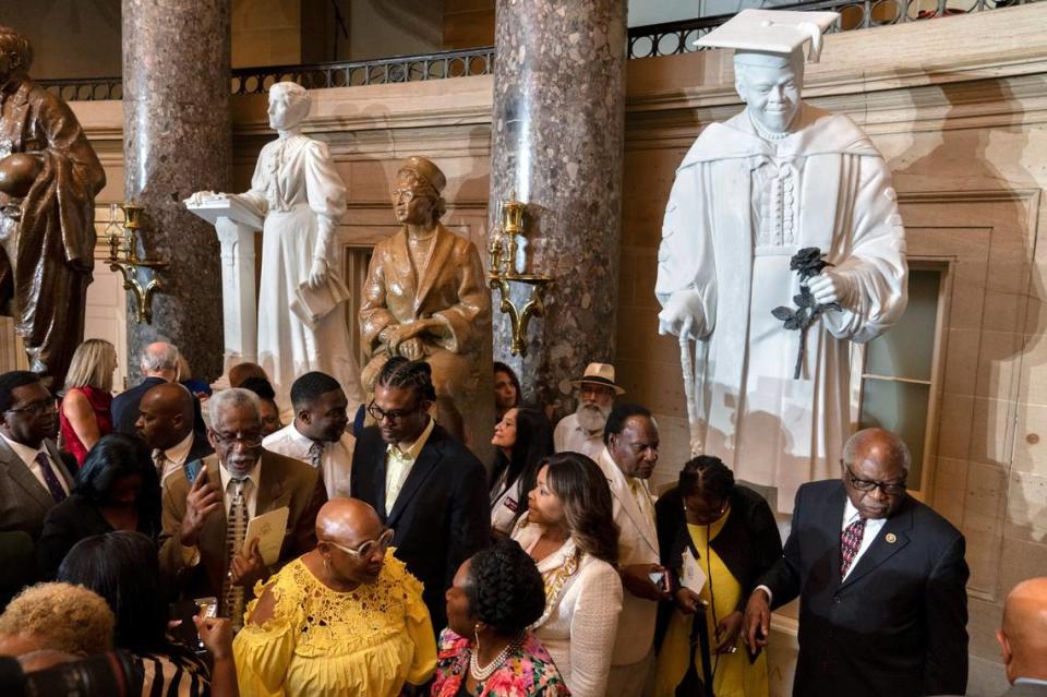 Evelyn Bethune, front left in yellow, a granddaughter of Mary McLeod Bethune, speaks with Rep. Sheila Jackson Lee, D-Texas, as members of the Congressional Black Caucus gather around an unveiled statue of Mary McLeod Bethune, at a ceremony for the statue, which is the first state statue of a Black woman in Statuary Hall, Wednesday, July 13, 2022, at the U.S. Capitol in Washington. Jacquelyn Martin/AP