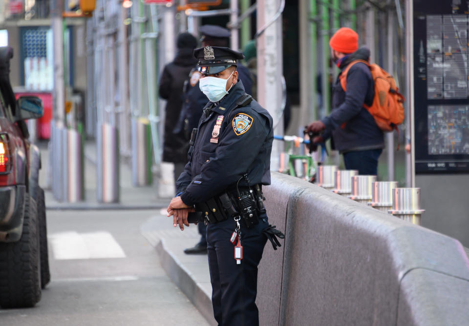 An NYPD police officer wears a protective face mask in Times Square on March 22. (Photo: Noam Galai via Getty Images)