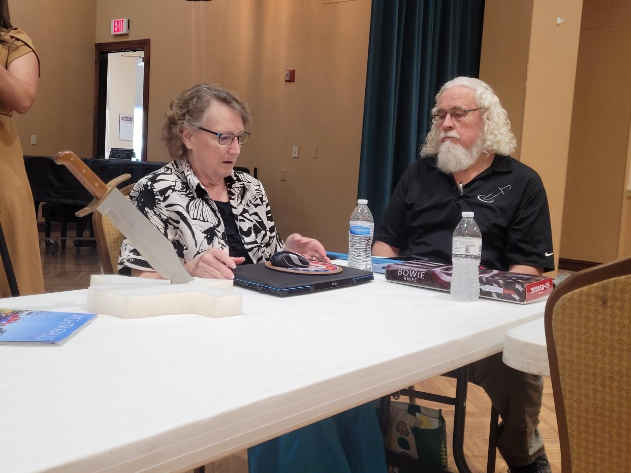 Gloria and Albert Schlabs sit at the Kemp Center for the Arts with a replica of the world's largest Bowie knife in front of them, Wednesday, Aug. 16, 2023.