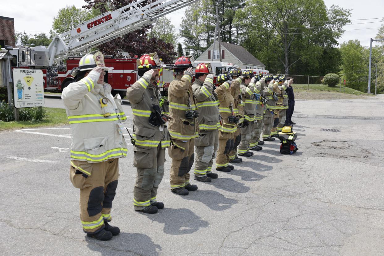 Members of the Spencer Fire Department salute in a file photo.